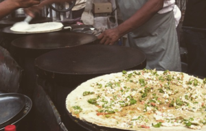 cast iron has more heat storage capacity that is why it is used in dosa making.